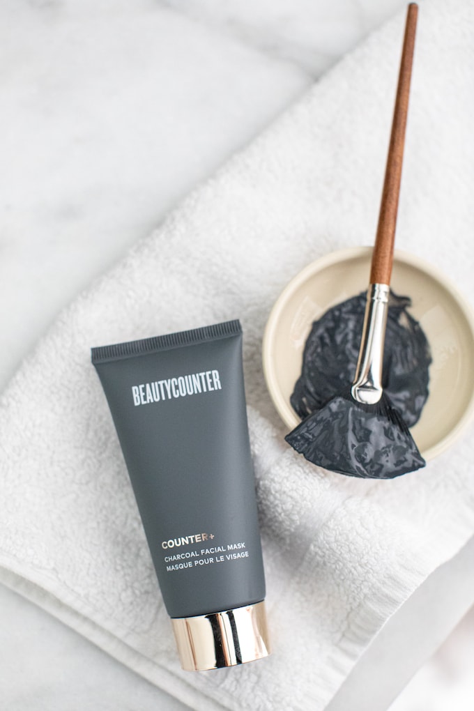 Beautycounter's Charcoal Mask in a bowl with a brush.