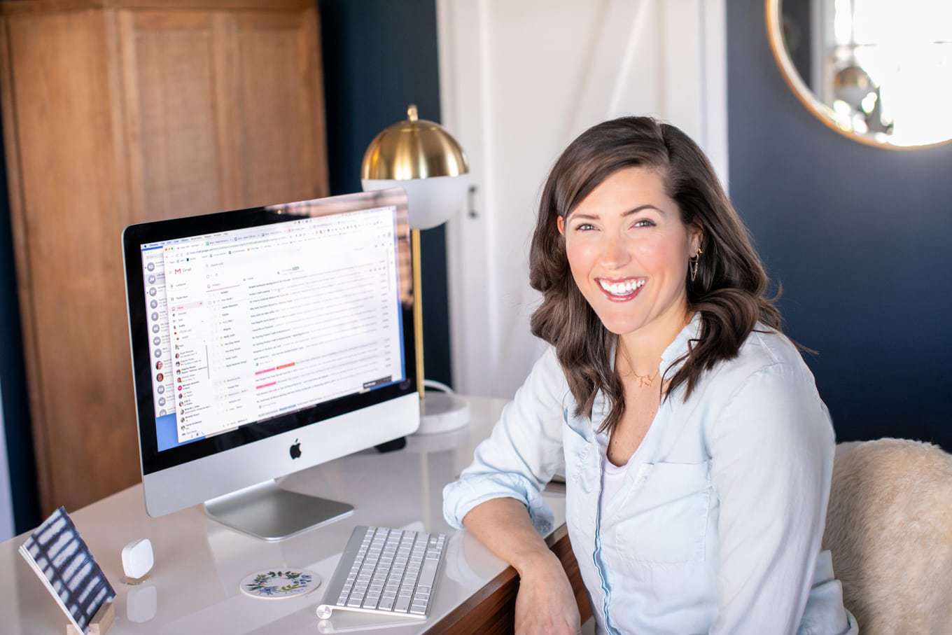 Kate Kordsmeier, sitting at her desk in front of a computer.