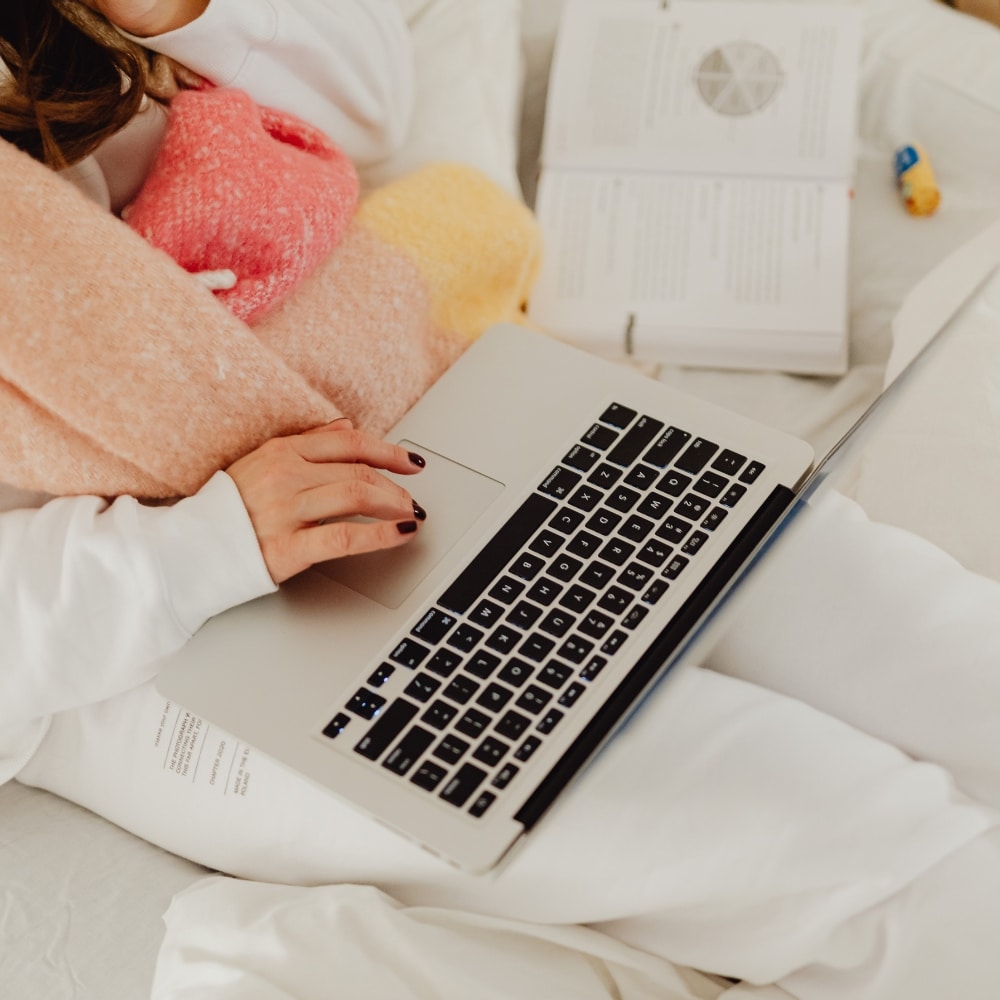 Cozy person working on laptop